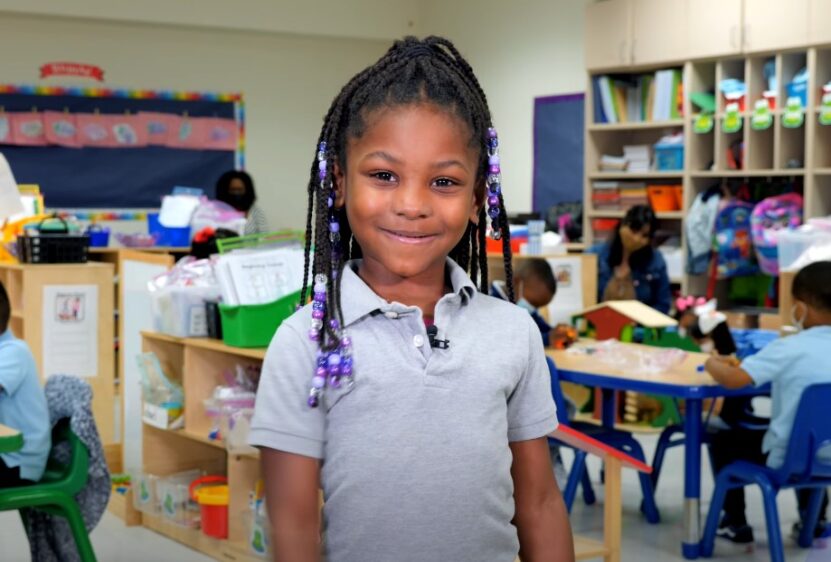 Cute girl posing for camera in kindergarten